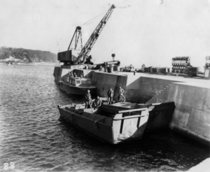 The boat dock with the picket and two Higgins boats. Note the large crane, which Gerry never saw used.